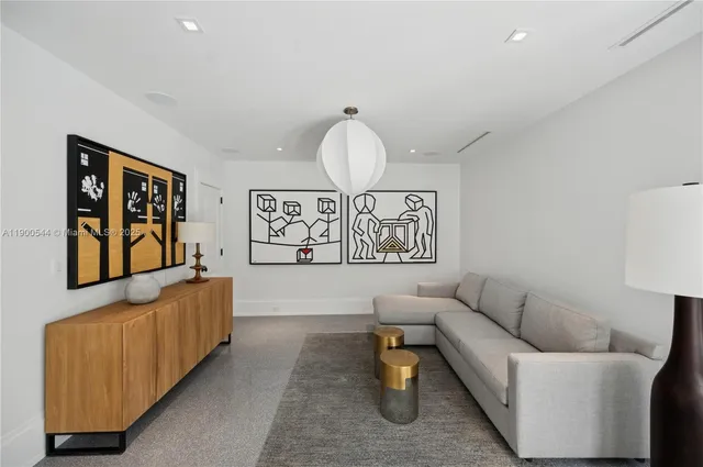 a living room with hardwood floor and large windows