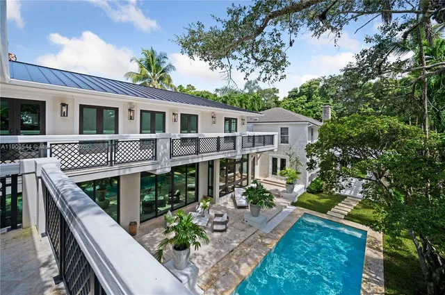 a view of a patio with table and chairs and potted plants