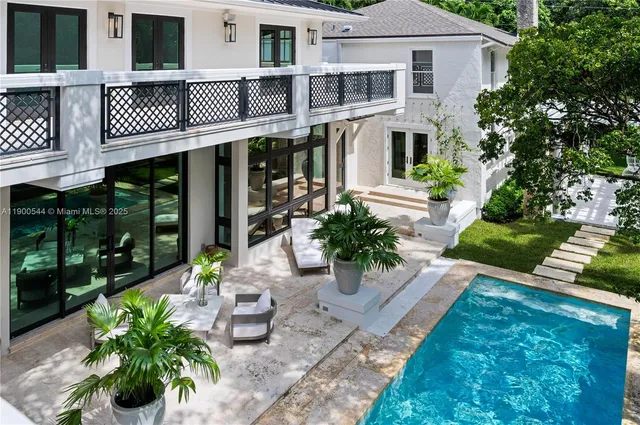 a dining room with furniture potted plants and wooden floor