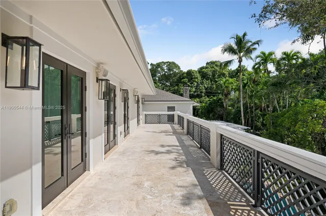 a view of a patio with table and chairs potted plants with wooden floor and fence