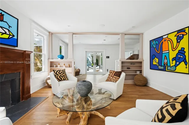 a living room with furniture and a chandelier