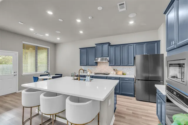 a kitchen with a sink and cabinets