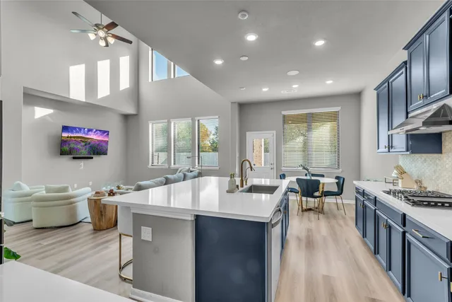 a kitchen with sink stove and cabinets