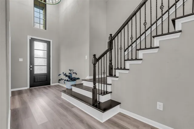 a living room with furniture kitchen view and large windows