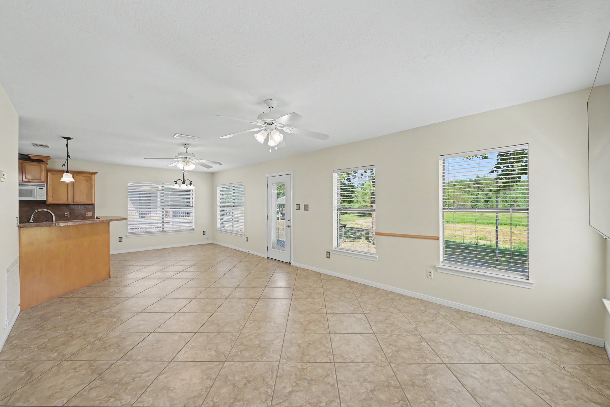 15 Lake Side Trinity, TX 75862 - Photo 3 of 29 Wide open space with windows facing the waterway.
