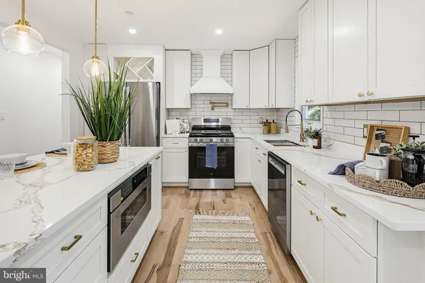 a kitchen with a sink stove and refrigerator
