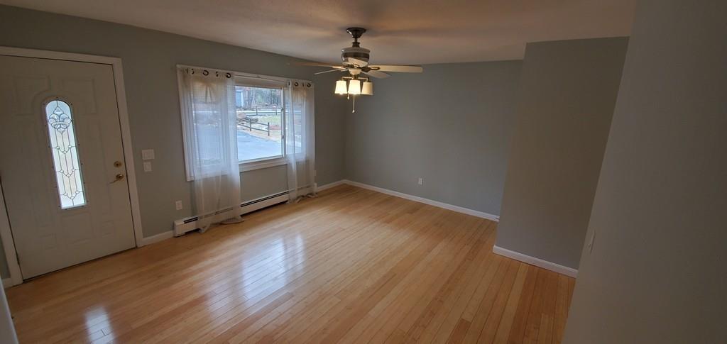 211 New Boston Road Sturbridge, MA 01566 - Photo 11 of 23 an empty room with wooden floor and windows