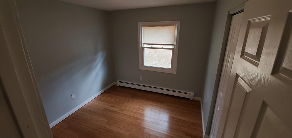 211 New Boston Road Sturbridge, MA 01566 - Photo 15 of 23 a view of an empty room with wooden floor and a window