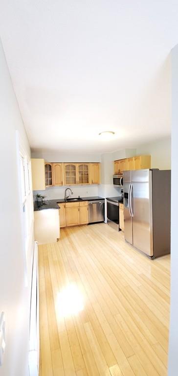 211 New Boston Road Sturbridge, MA 01566 - Photo 9 of 23 a view of a kitchen with kitchen island a sink wooden floor and living room view