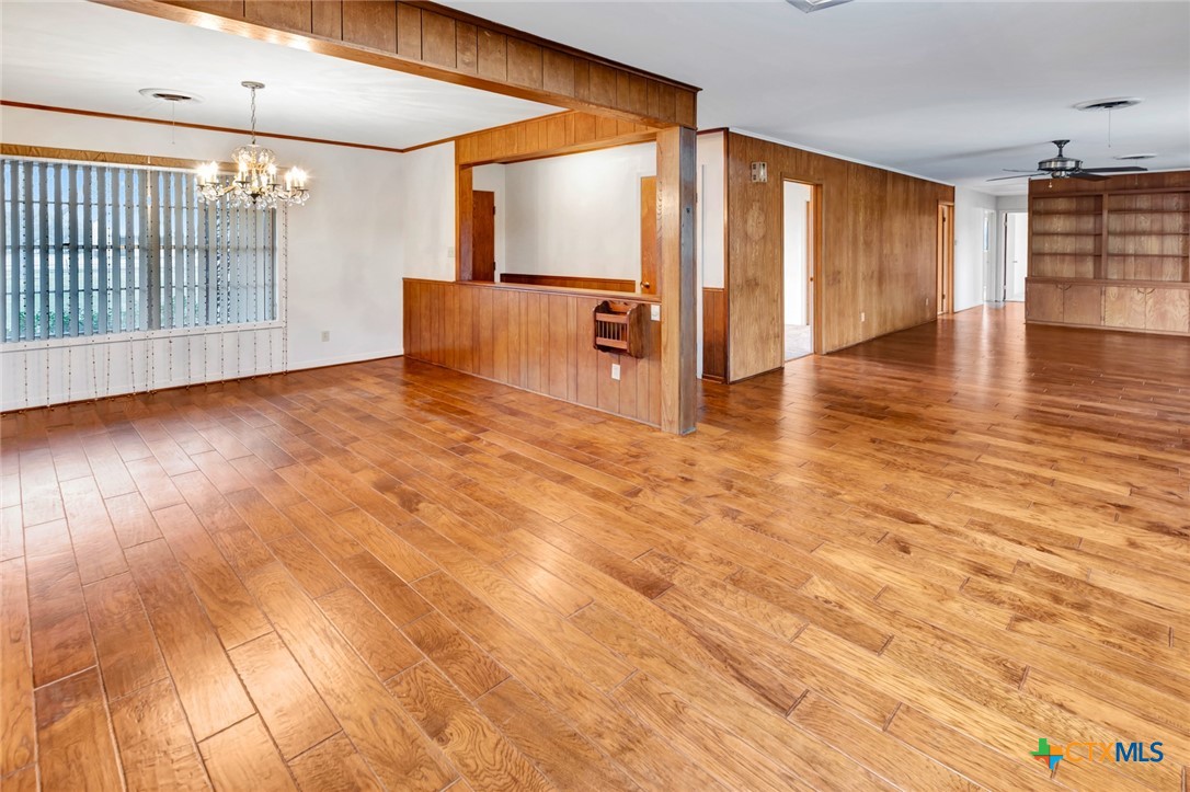 711 Northgate Road Victoria, TX 77904 - Photo 11 of 37 a view of an empty room with wooden floor and stairs