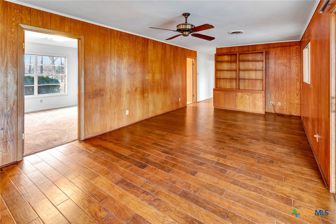 711 Northgate Road Victoria, TX 77904 - Photo 13 of 37 a view of empty room with wooden floor and fan