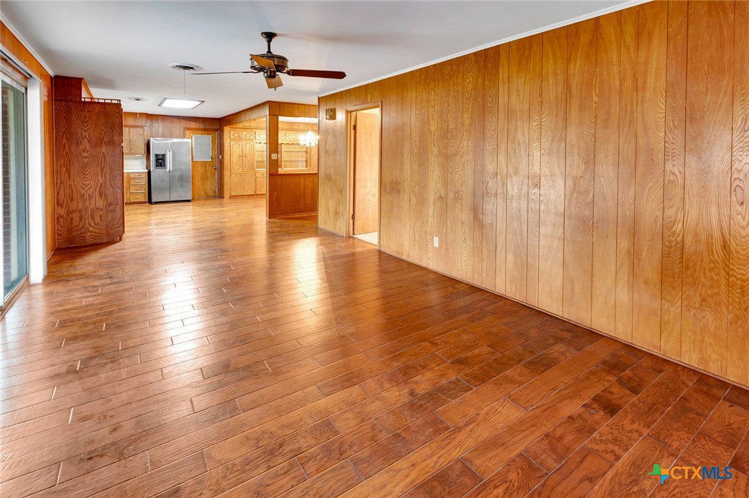 711 Northgate Road Victoria, TX 77904 - Photo 14 of 37 wooden floor in an empty room with a window