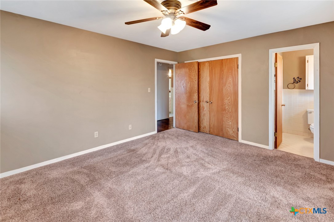 711 Northgate Road Victoria, TX 77904 - Photo 25 of 37 a view of an empty room with window and a chandelier fan