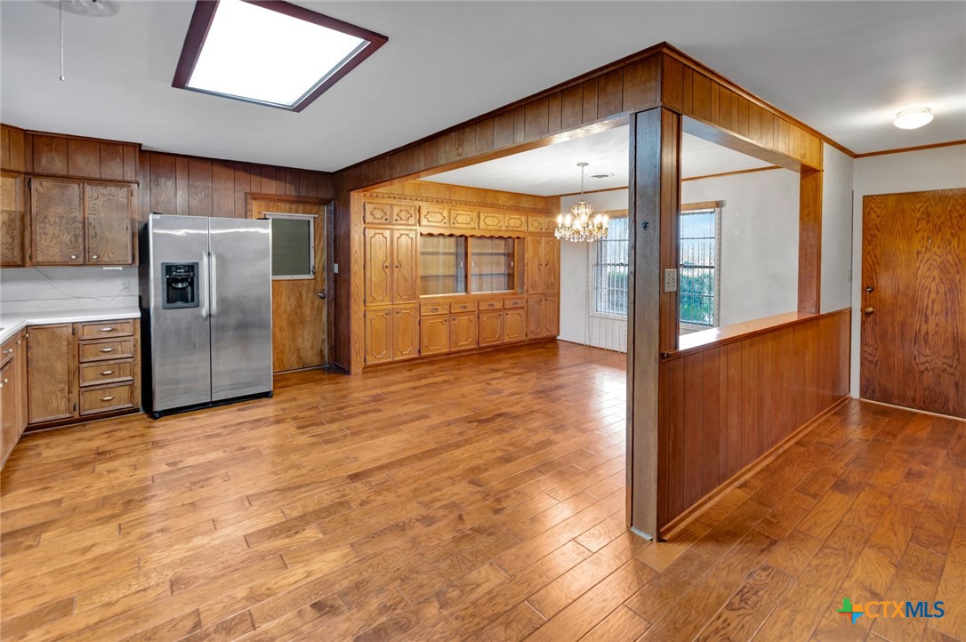 711 Northgate Road Victoria, TX 77904 - Photo 4 of 37 an empty room with wooden floor and windows