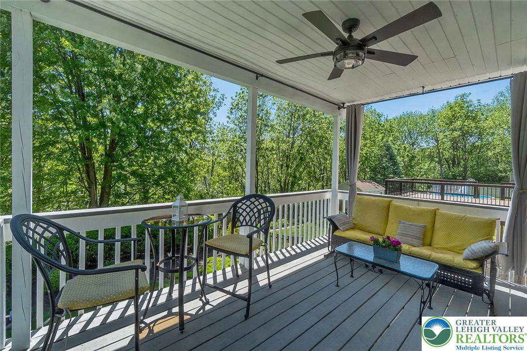 2314 Red Maple Drive Coplay, PA 18037 - Photo 58 of 73 Enjoy tranquil treetop views and fresh breezes on this inviting outdoor deck, complete with a refreshing ceiling fan.