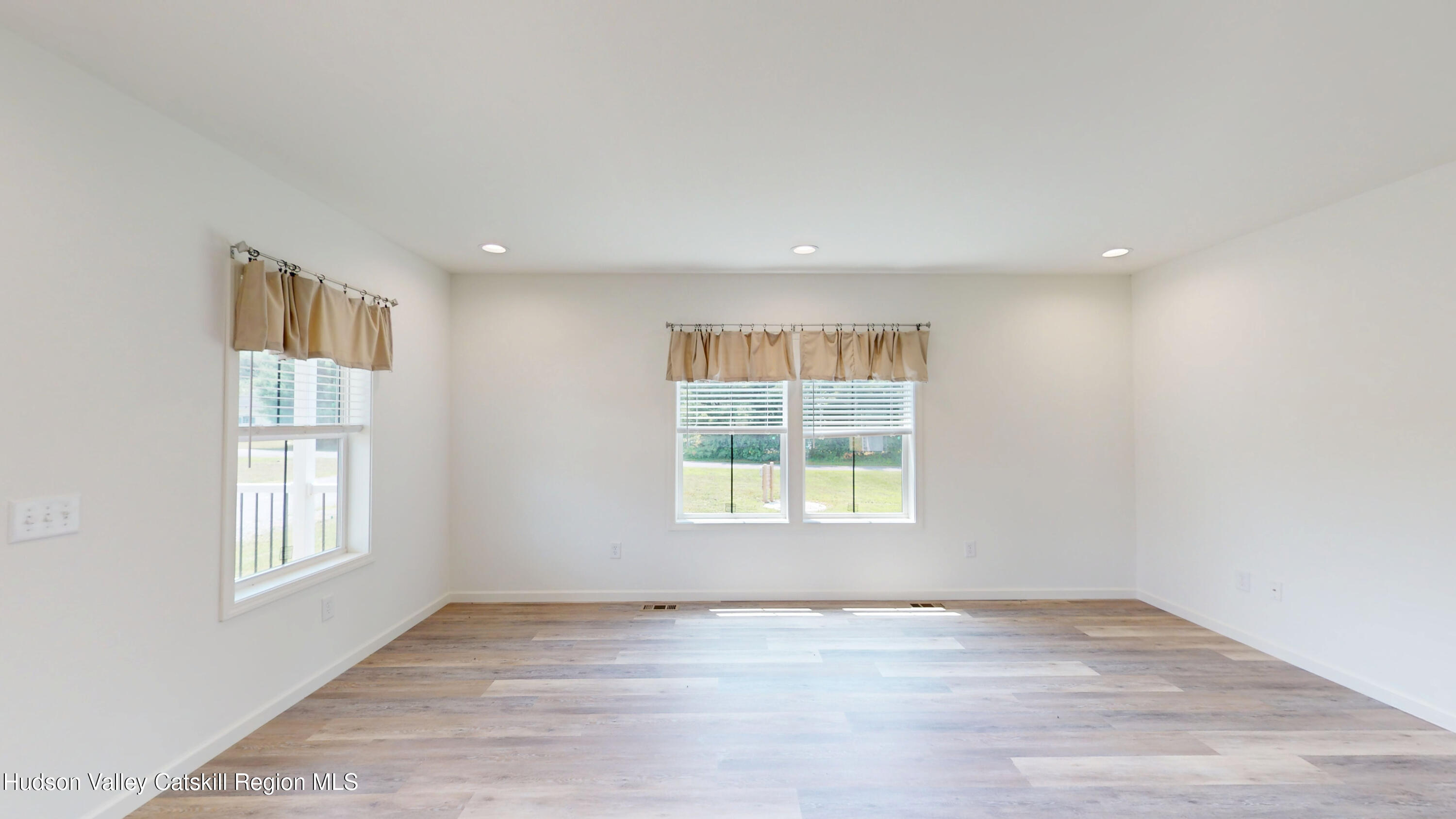19 Mahoney Road Stuyvesant, NY 12173 - Photo 11 of 32 an empty room with wooden floor and windows