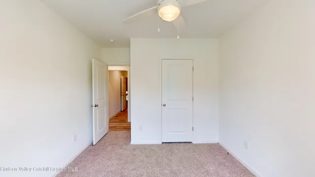 a view of room with window and ceiling fan