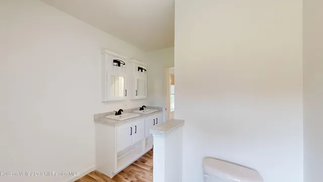 a bathroom with a sink toilet and mirror