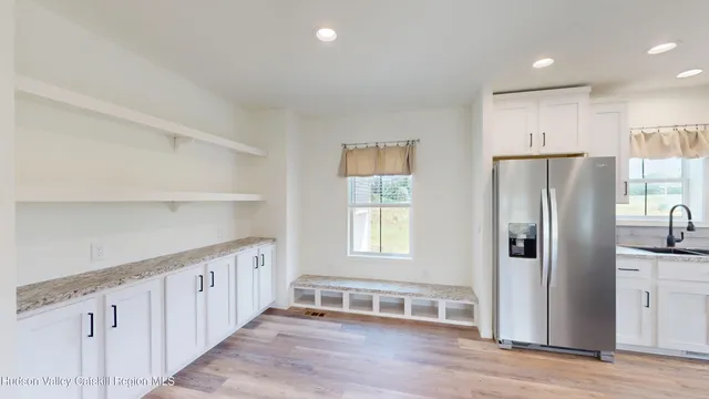 a view of a kitchen with wooden floor and cabinets