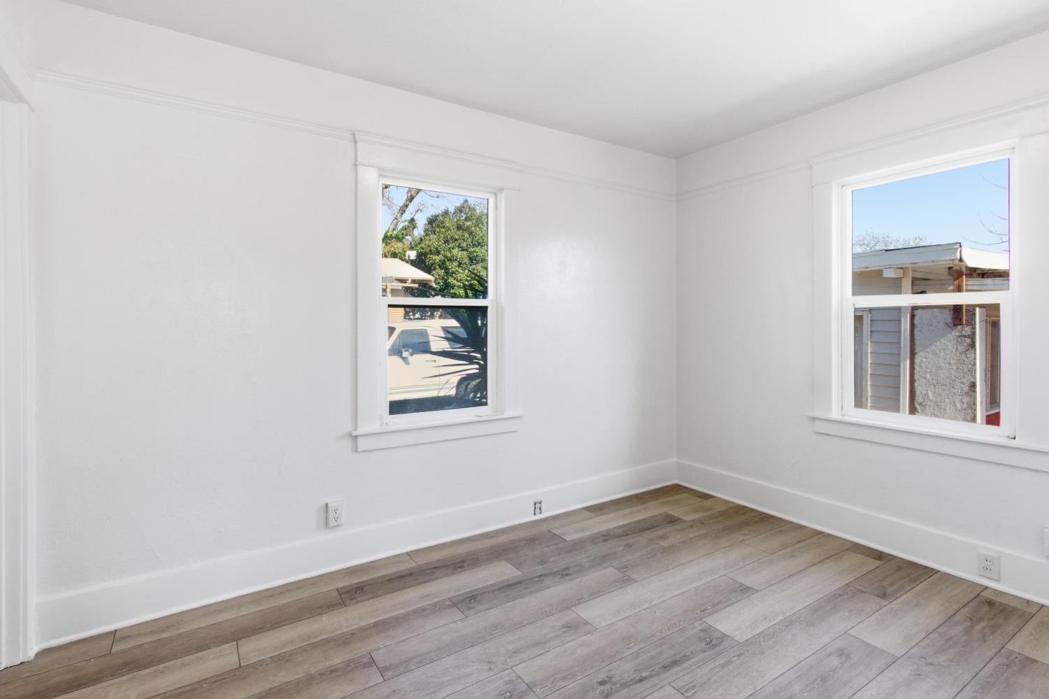 1014 3rd Street Los Banos, CA 93635 - Photo 11 of 21 an empty room with wooden floor and windows