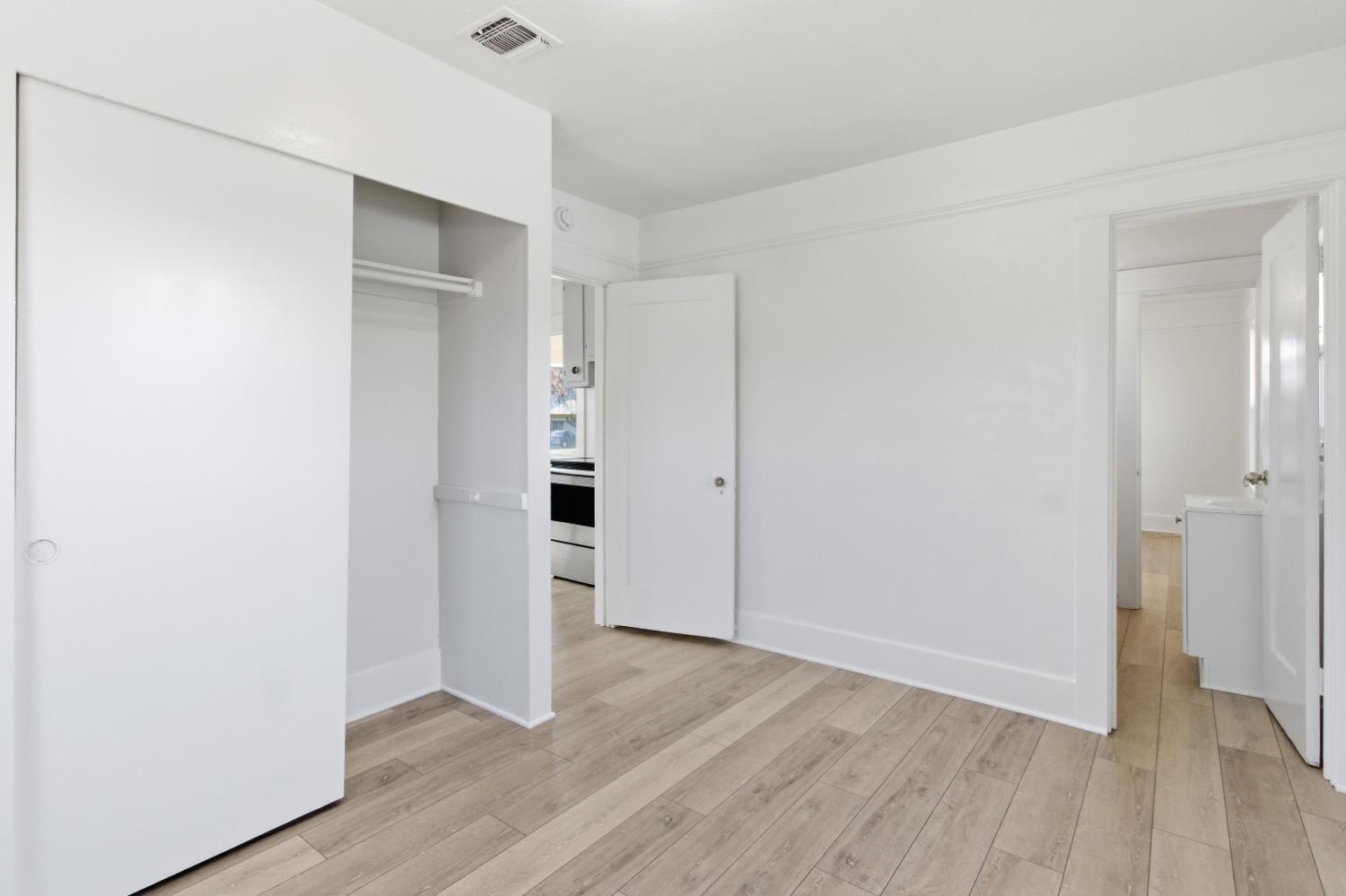 1014 3rd Street Los Banos, CA 93635 - Photo 12 of 21 an empty room with wooden floor