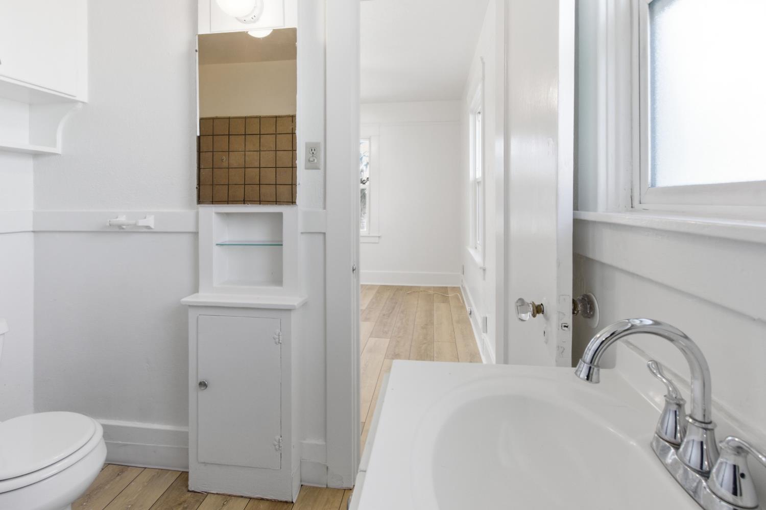1014 3rd Street Los Banos, CA 93635 - Photo 14 of 21 a bathroom with a sink and a toilet