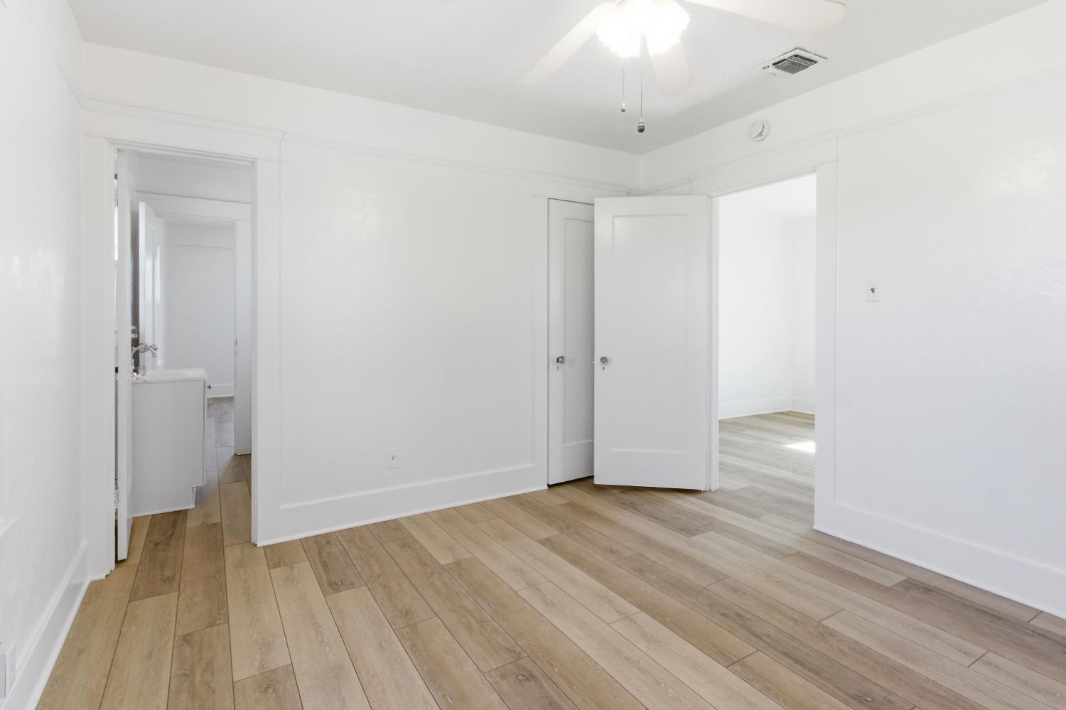 1014 3rd Street Los Banos, CA 93635 - Photo 16 of 21 wooden floor in an empty room with a window