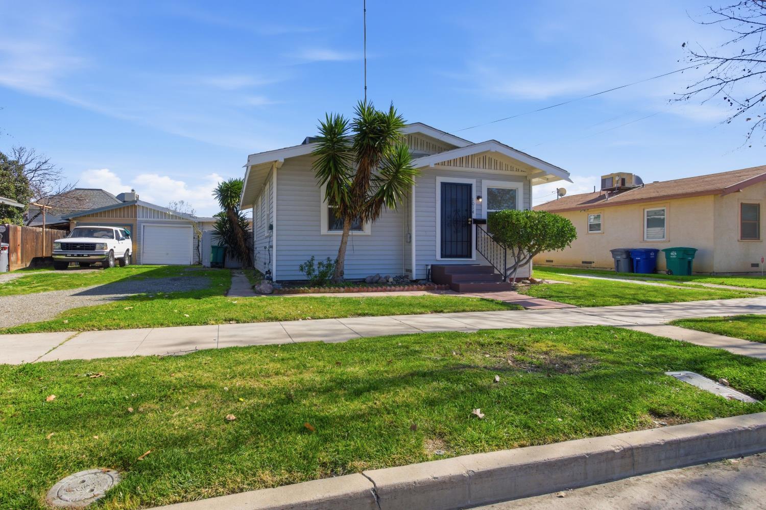 1014 3rd Street Los Banos, CA 93635 - Photo 3 of 21 a front view of a house with a yard and garage