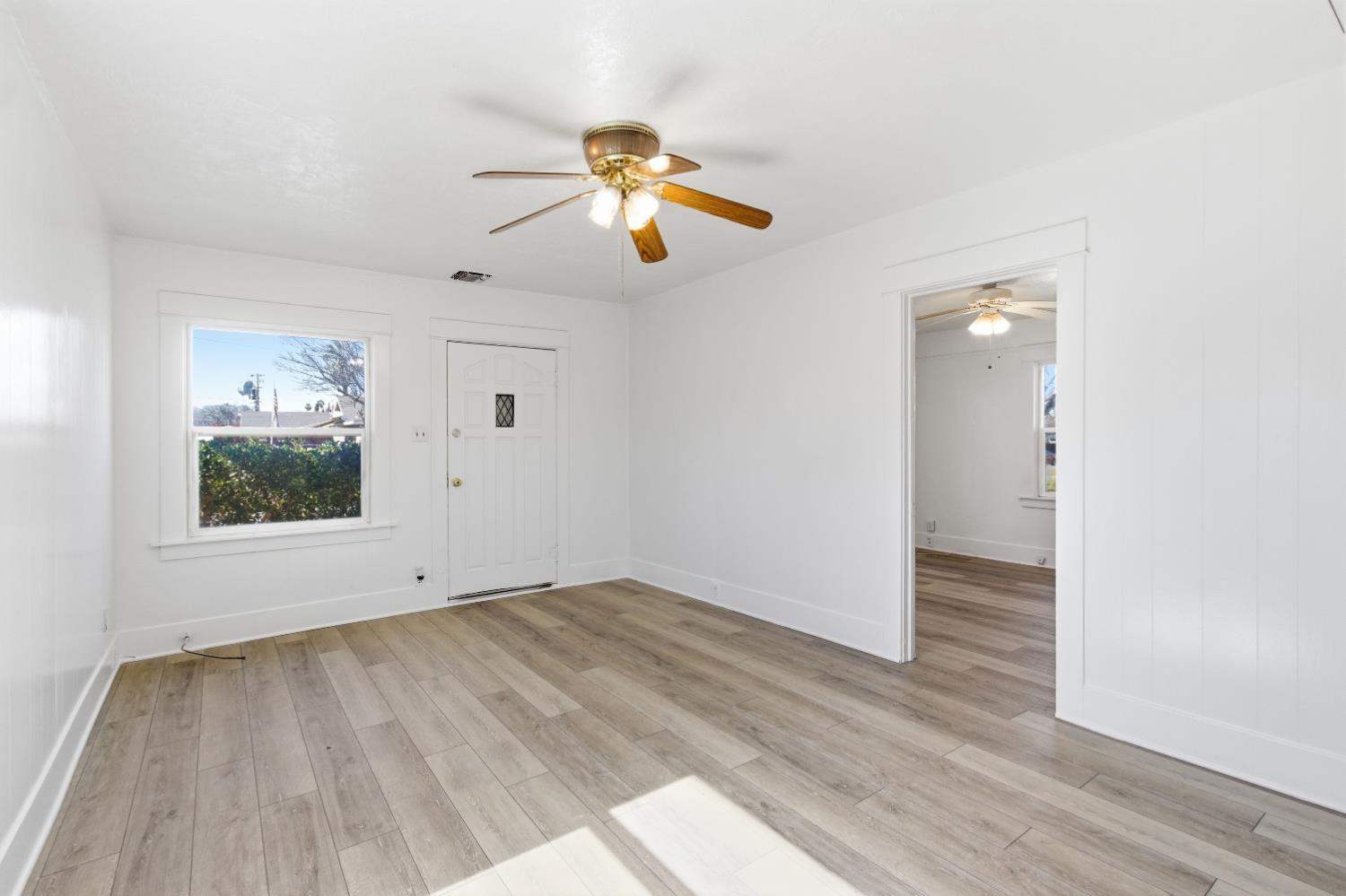 1014 3rd Street Los Banos, CA 93635 - Photo 5 of 21 wooden floor in an empty room with a window