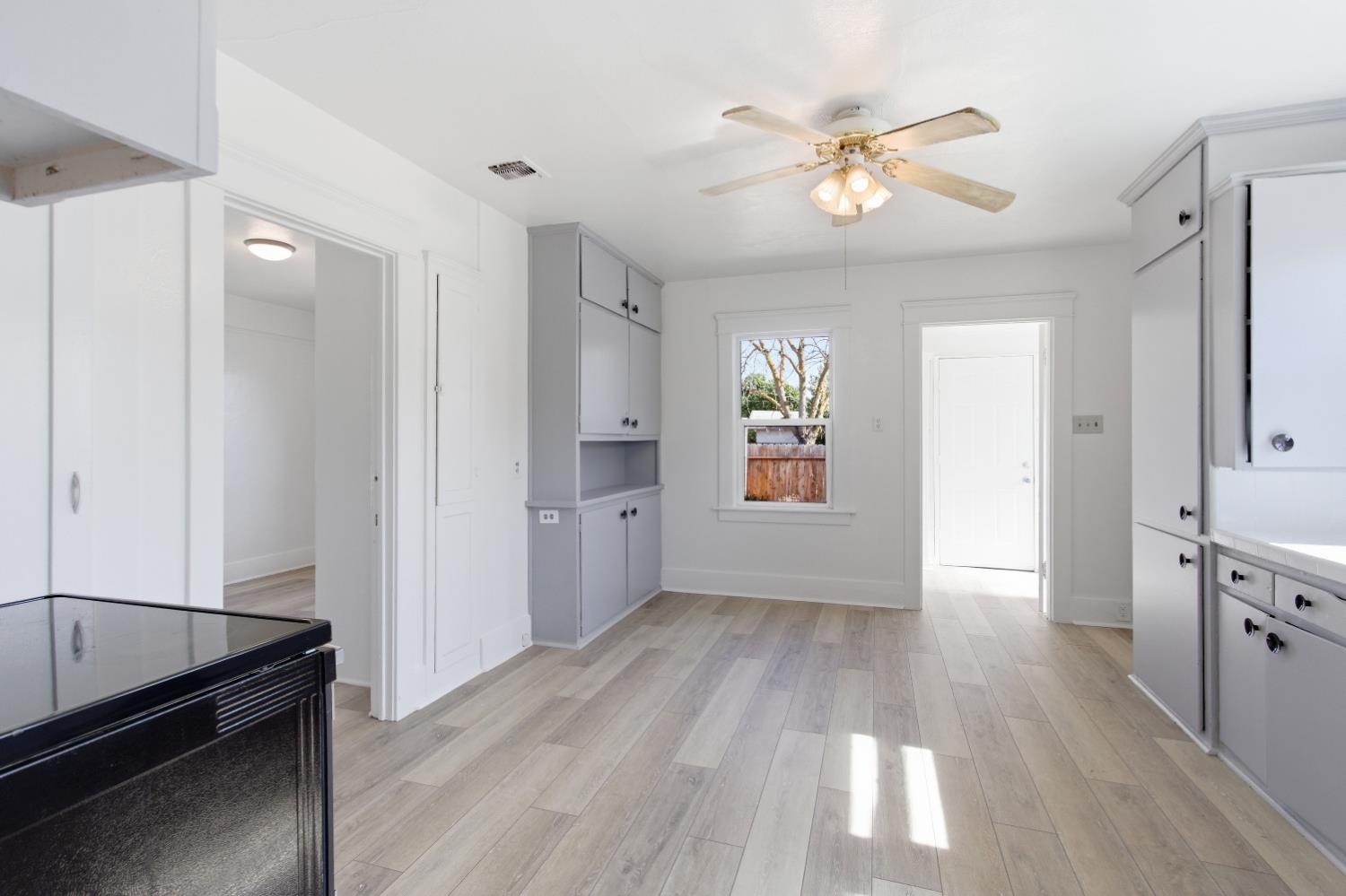 1014 3rd Street Los Banos, CA 93635 - Photo 6 of 21 a view of an empty room with window and wooden floor