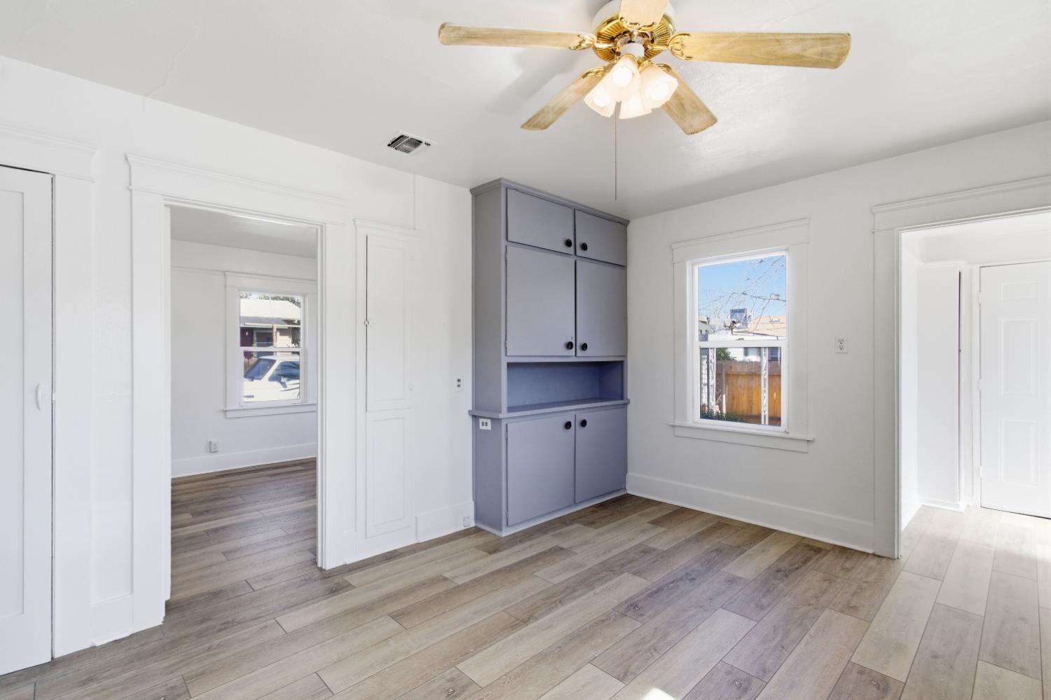 1014 3rd Street Los Banos, CA 93635 - Photo 9 of 21 wooden floor in an empty room with a window