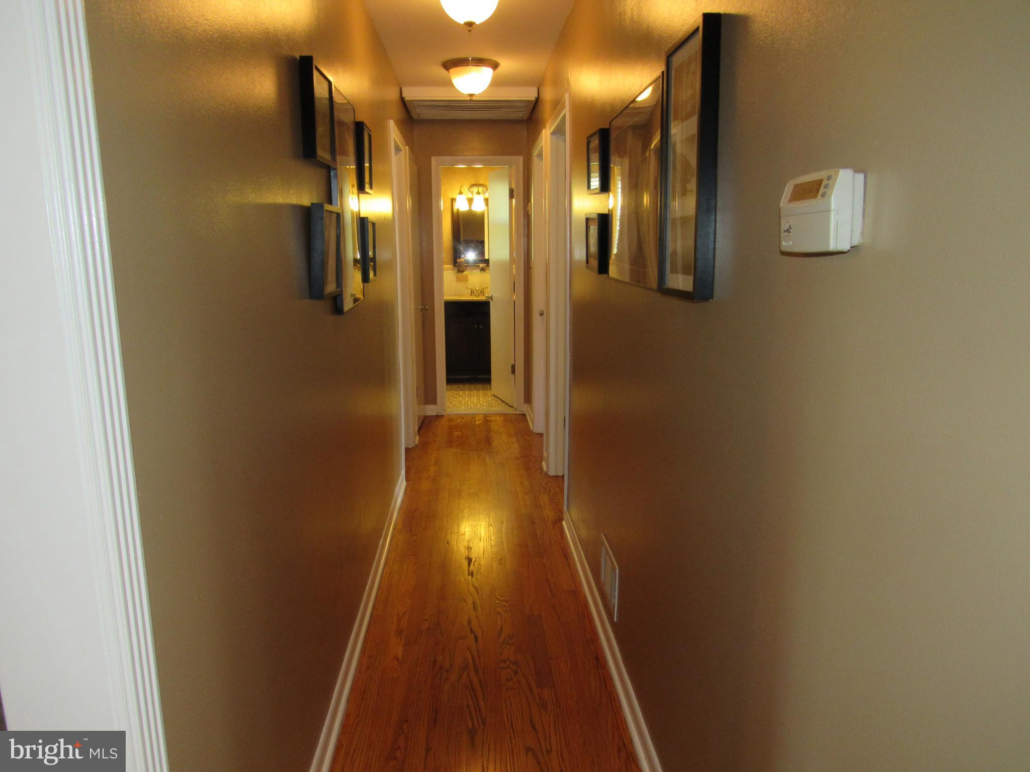 8710 Windsor Mill Road Baltimore, MD 21244 - Photo 12 of 30 a view of a hallway with wooden floor