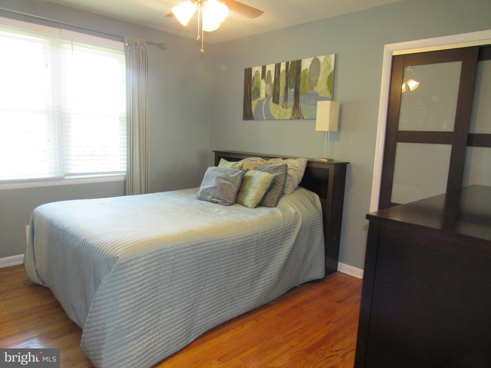 8710 Windsor Mill Road Baltimore, MD 21244 - Photo 16 of 30 a bedroom with a bed and a window