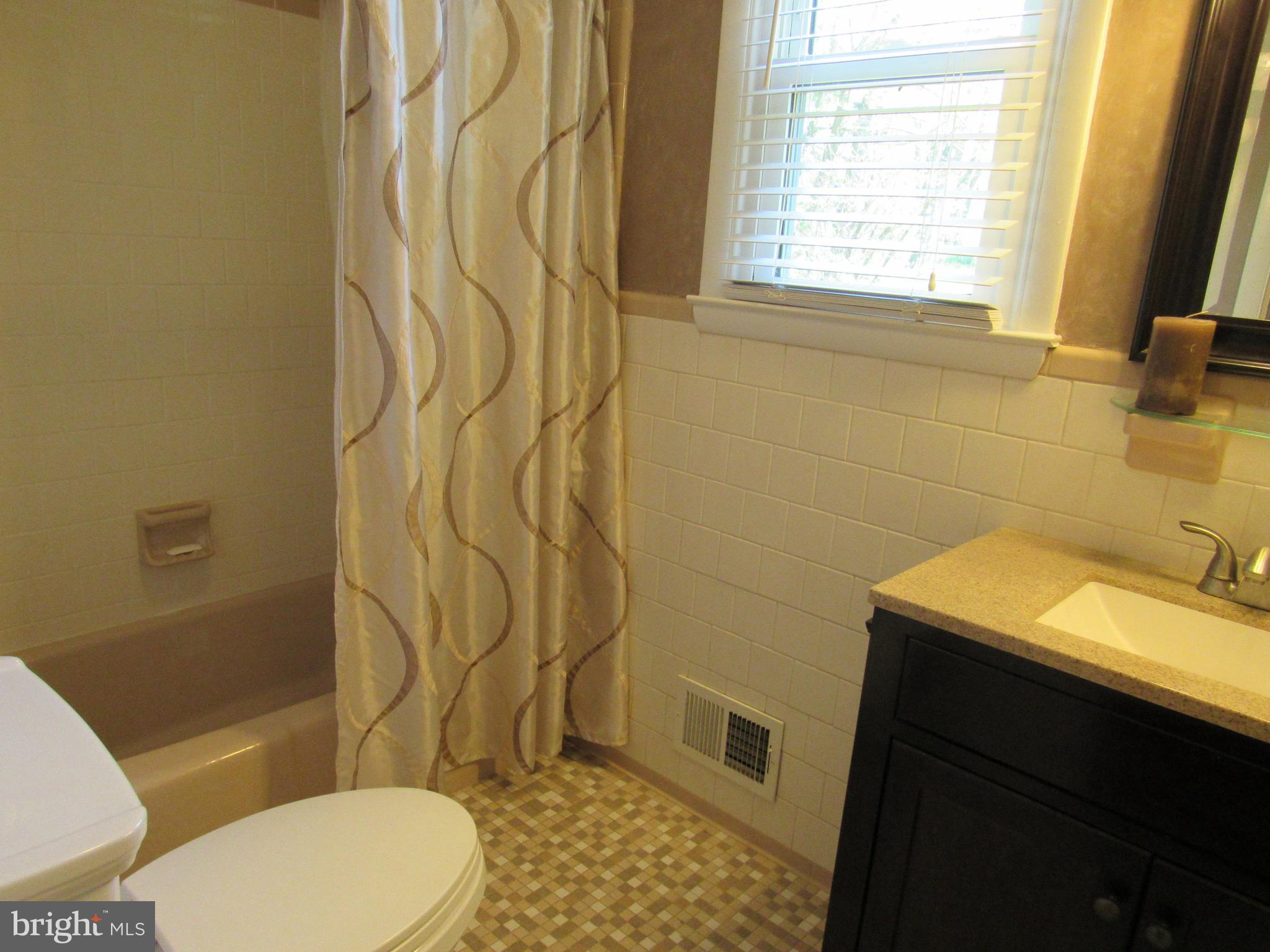 8710 Windsor Mill Road Baltimore, MD 21244 - Photo 18 of 30 a bathroom with a sink toilet and shower