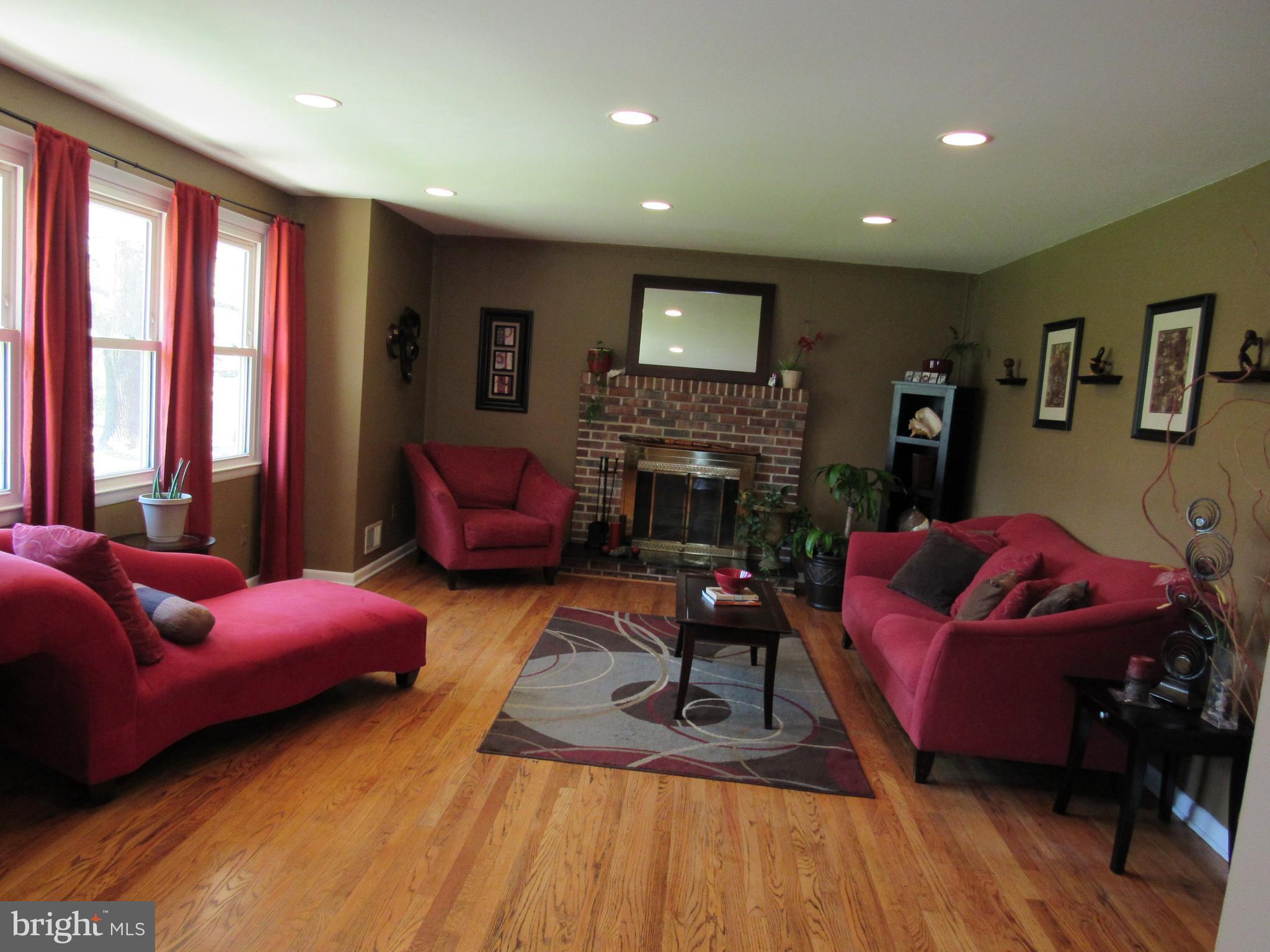 8710 Windsor Mill Road Baltimore, MD 21244 - Photo 3 of 30 a living room with furniture and a fireplace