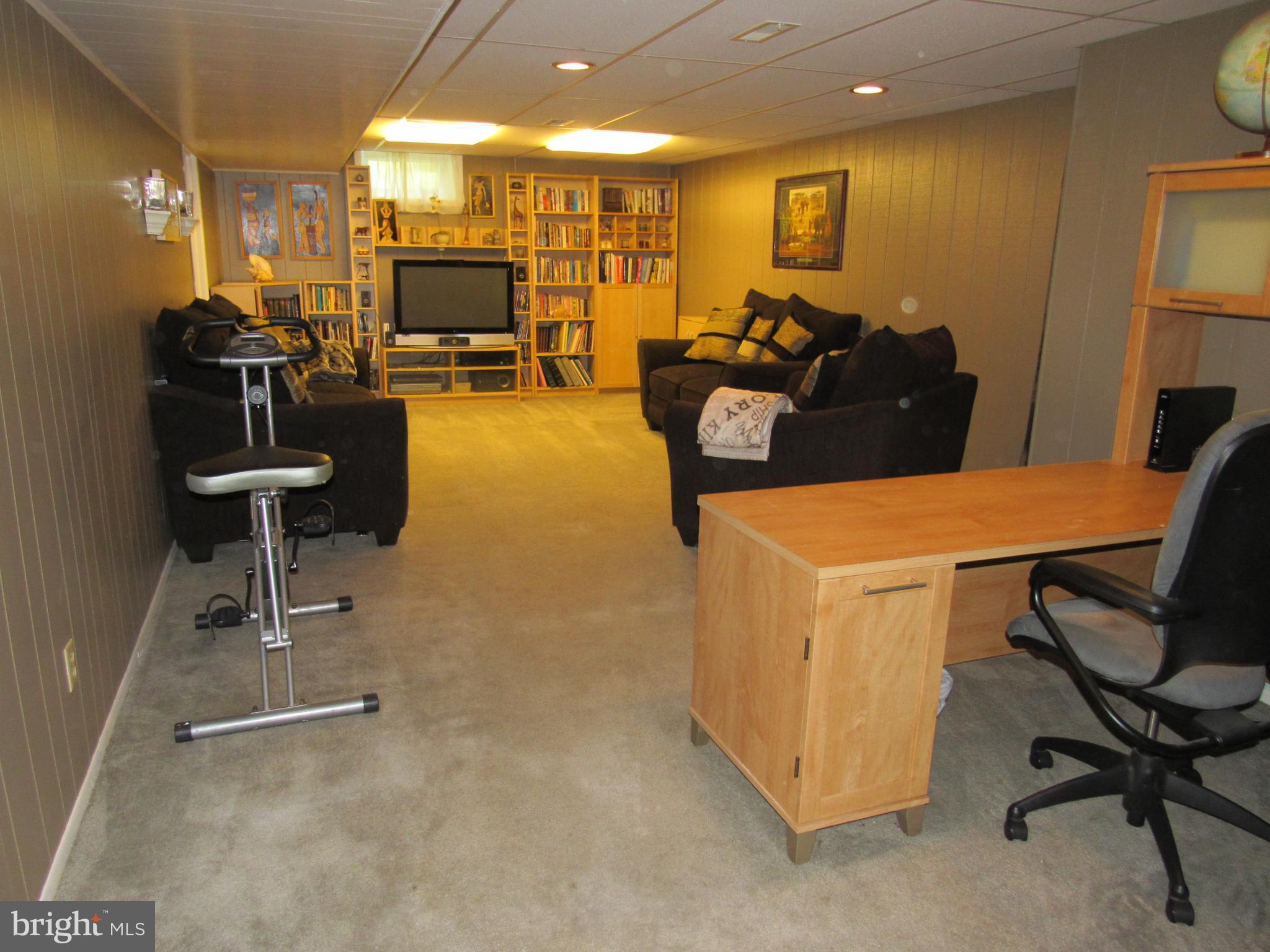 8710 Windsor Mill Road Baltimore, MD 21244 - Photo 22 of 30 a view of a livingroom with furniture and a flat screen tv