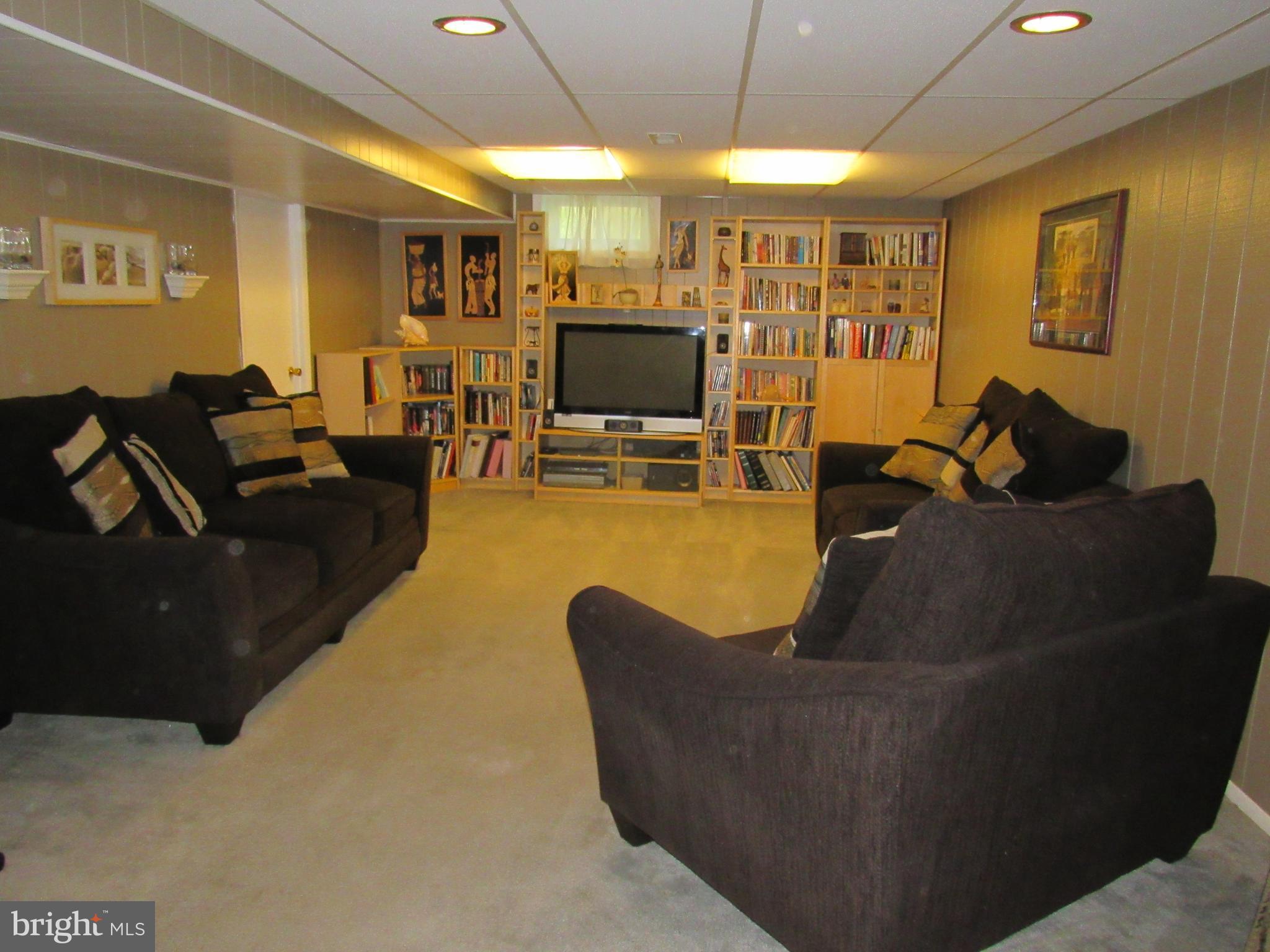8710 Windsor Mill Road Baltimore, MD 21244 - Photo 23 of 30 a living room with furniture and a flat screen tv