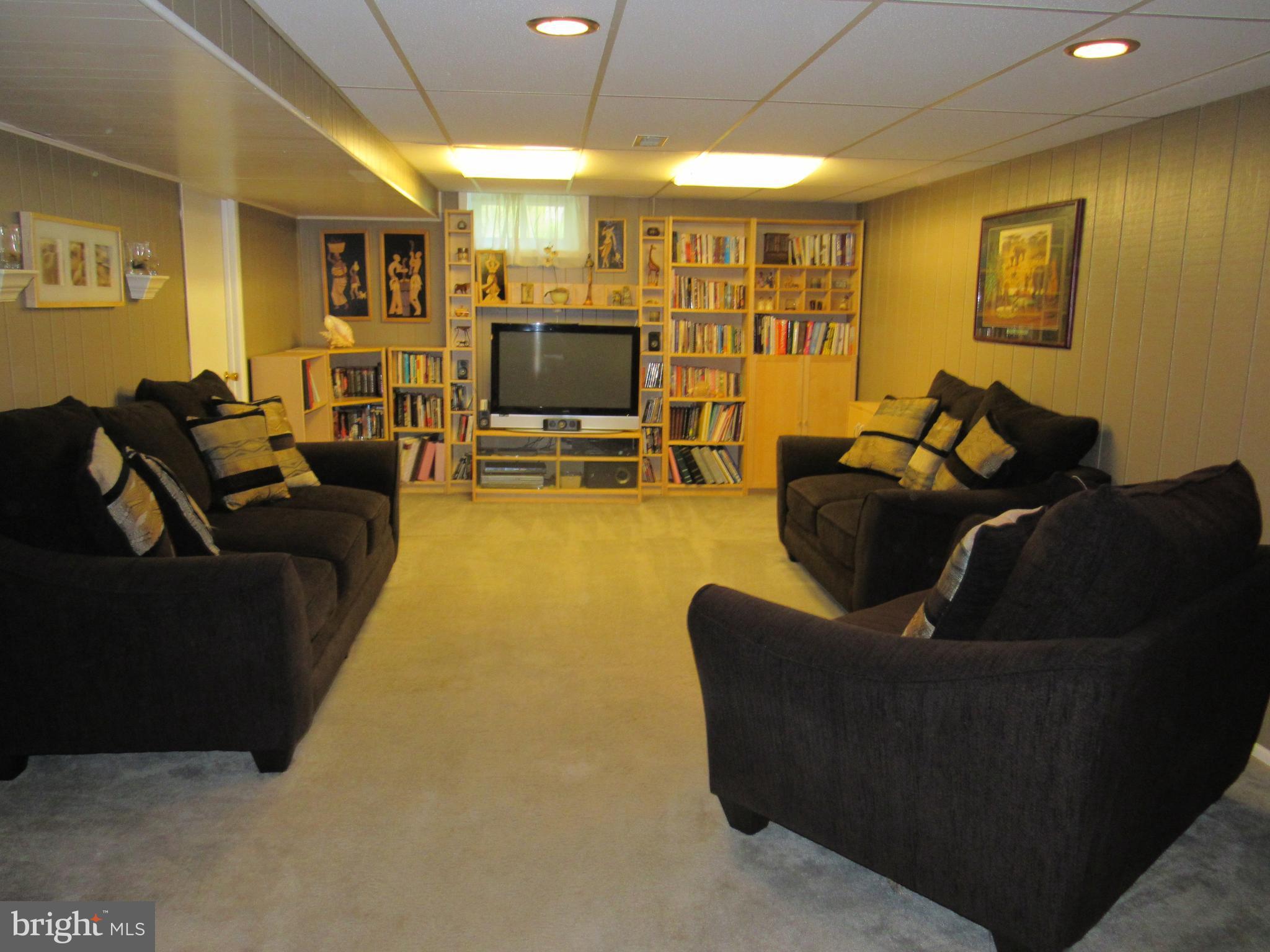 8710 Windsor Mill Road Baltimore, MD 21244 - Photo 24 of 30 a living room with furniture and a flat screen tv