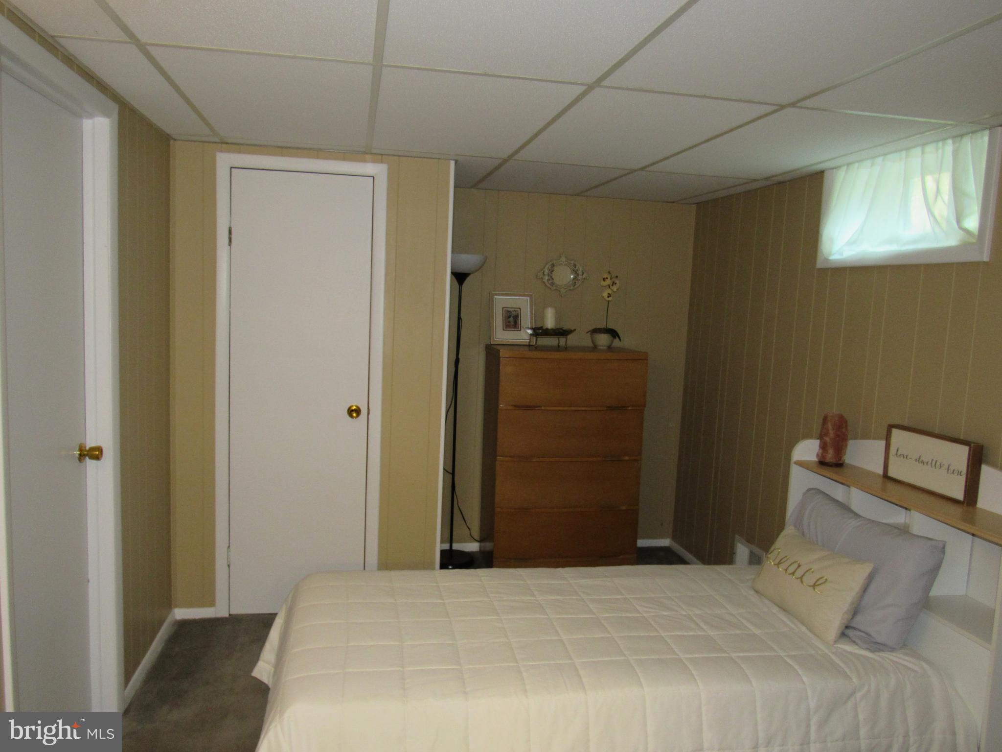 8710 Windsor Mill Road Baltimore, MD 21244 - Photo 25 of 30 a bedroom with a bed and a walk in closet