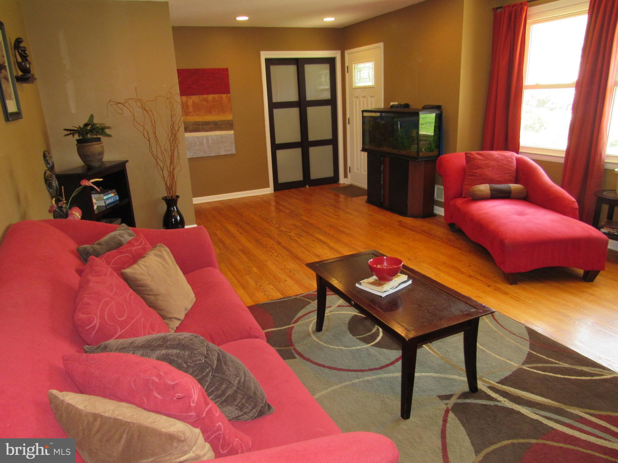 8710 Windsor Mill Road Baltimore, MD 21244 - Photo 5 of 30 a bedroom with a bed and wooden floor