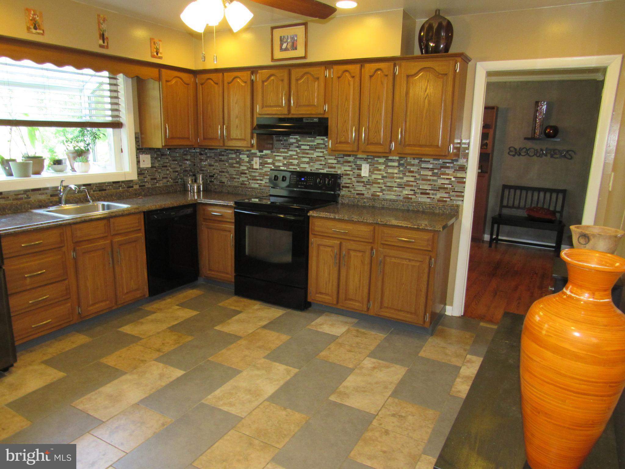 8710 Windsor Mill Road Baltimore, MD 21244 - Photo 10 of 30 a kitchen with stainless steel appliances granite countertop a sink and cabinets
