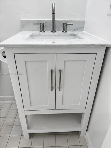 a white toilet and tub sitting next to a bathroom sink