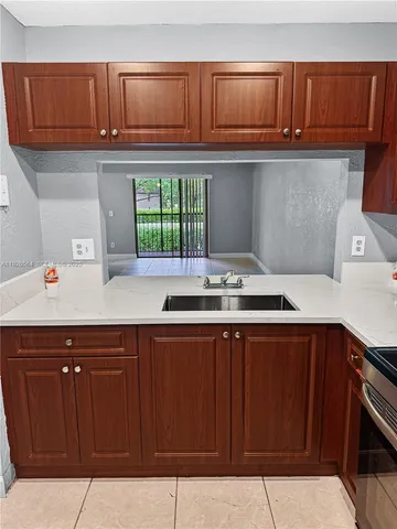 a kitchen with stainless steel appliances granite countertop a sink and cabinets