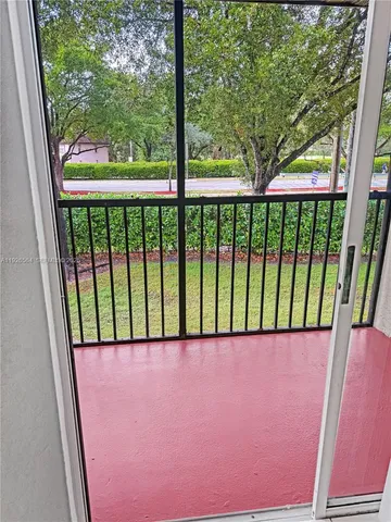 a blue sign broad in front of a yard