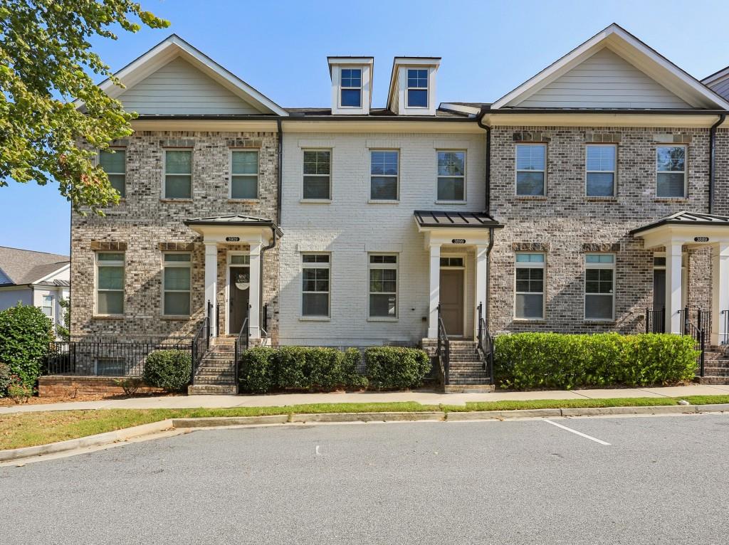 3899 Glenview Club Lane Duluth, GA 30097 - Photo 1 of 38 a front view of a house with a yard and a garage