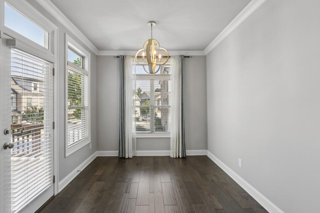 3899 Glenview Club Lane Duluth, GA 30097 - Photo 17 of 38 wooden floor in an empty room with a window