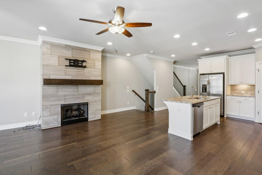 3899 Glenview Club Lane Duluth, GA 30097 - Photo 19 of 38 a living room with furniture and a fireplace