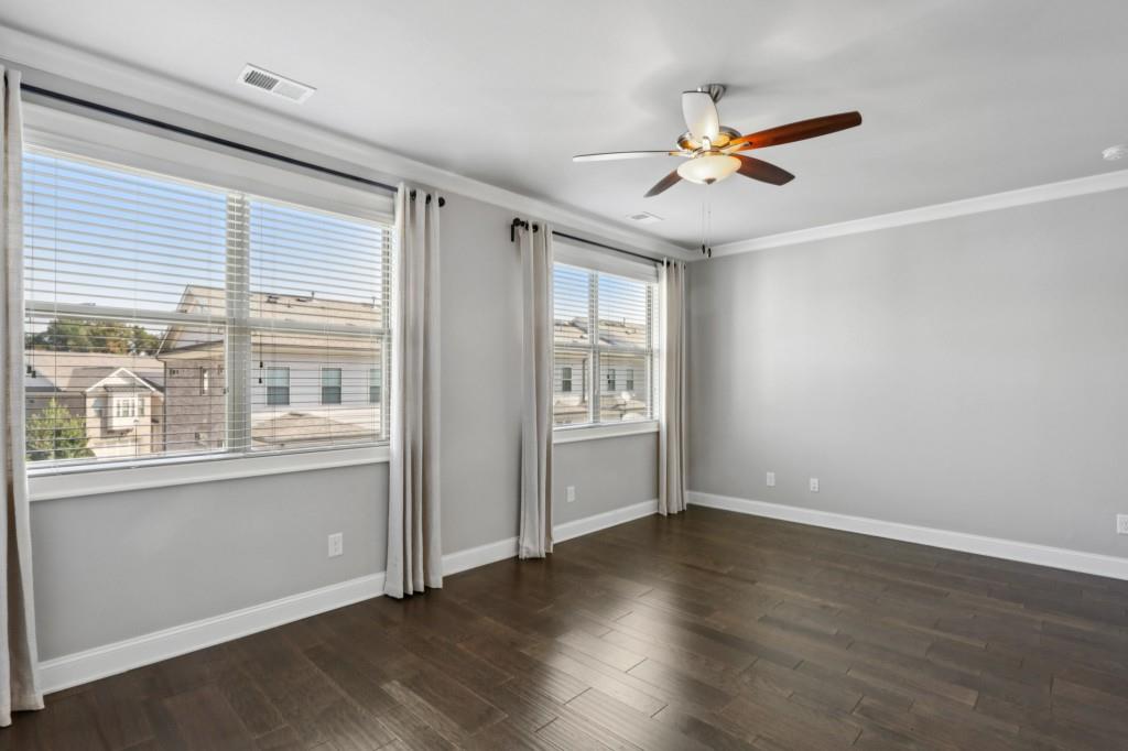 3899 Glenview Club Lane Duluth, GA 30097 - Photo 20 of 38 an empty room with wooden floor fan and windows