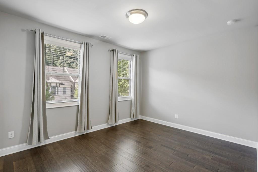 3899 Glenview Club Lane Duluth, GA 30097 - Photo 26 of 38 an empty room with wooden floor and windows
