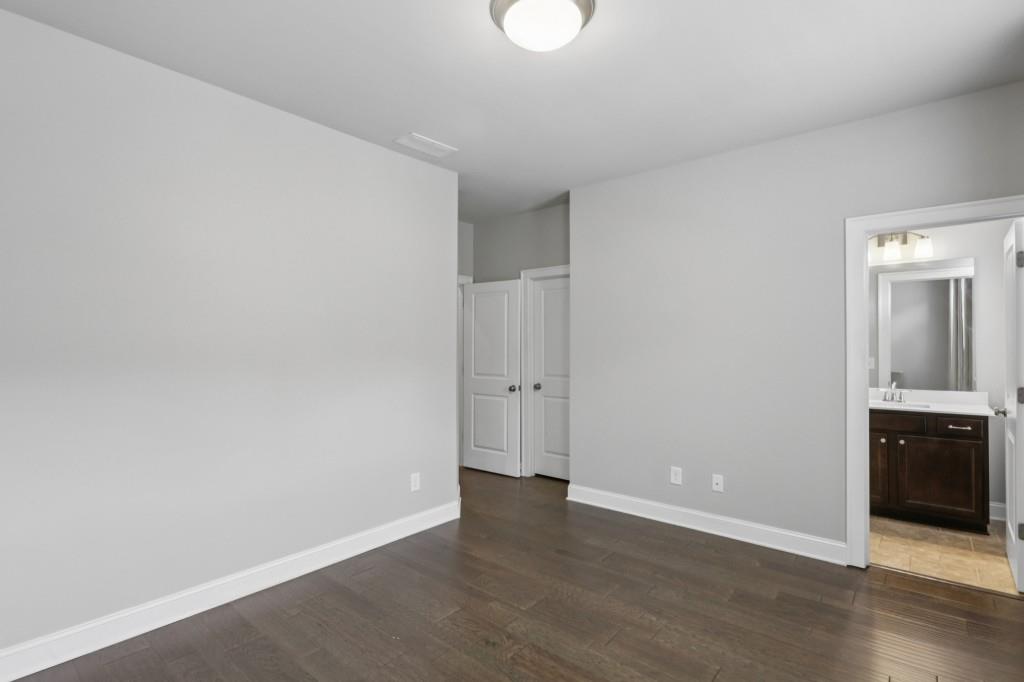 3899 Glenview Club Lane Duluth, GA 30097 - Photo 27 of 38 a view of an empty room with wooden floor and a window